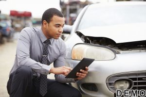42308954 - loss adjuster using digital tablet in car wreck inspection